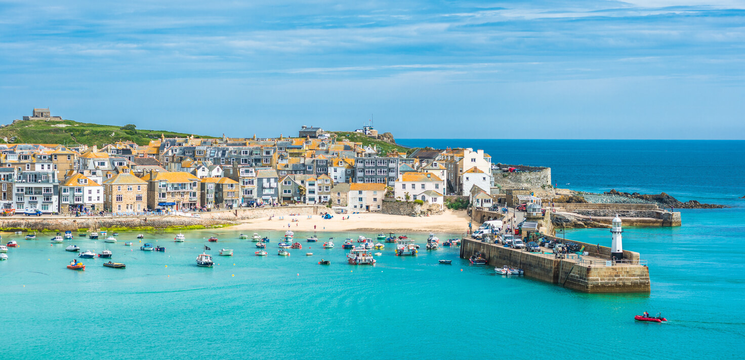 St. Ives harbor with colorful boats and whitewashed buildings
