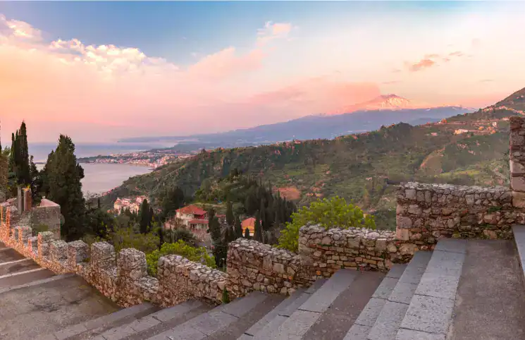 Mount Etna at sunrise over the Sicilian coast